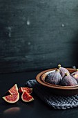 Fresh figs in a ceramic bowl and next to it