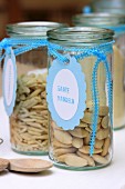 Almonds in storage jars with hand-crafted labels