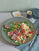 Rice salad with chickpeas and grilled black caraway tuna fish