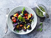 Blue potato salad with peppers and cherry tomatoes (vegetarian)