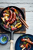 Lamb sausages with vegetables braised in red wine (Turkey)