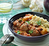 Lamb meatballs in a spicy sauce with couscous