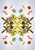 A digital composition of mirrored images of of a mixed vegetable salad