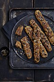 Gluten-free wholemeal bread sticks topped with seeds