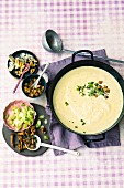 Potato and parsnip soup with various toppings