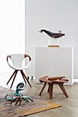 Designer armchair, walnut stool and stylised animal sculptures