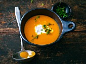 Exotic carrot soup with ginger and sour cream