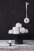 Bundt cakes made from a sand and putty mixture as decorations on a cake stand