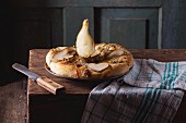 Pizza with gorgonzola and pears on a rustic wooden table