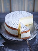 Creamy cheese cake with icing sugar, sliced