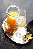 A glass of sparkling wine with orange juice