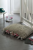 Homemade floor cushion with tassels