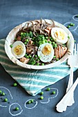 Soba noodles with salmon, broccoli, peas and halved eggs