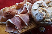 Supper with Vinschgau bread (rye-wheat sour dough) and air-dried country ham on a wooden board