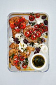 Bread salad with baked cherry tomatoes, olives and mozzarella