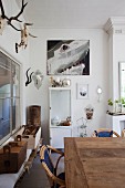 Rustic dining area, white vintage locker and hunting trophies on wall