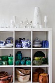 Crockery and china painted blue and white on white shelves