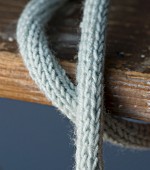 Homemade knitted cable protector for a light bulb (close up)