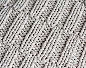 A knitted pattern with offset ribbing (full frame)