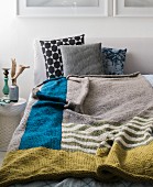 Homemade knitted colour block blanket made from a mixed wool yarn