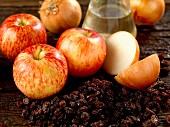 Ingredients for making chutney with apples, raisins, onions and white wine vinegar