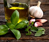 Ingredients for a salad dressing with olive oil, garlic, oregano, thyme and basil