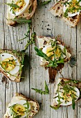 Slices of bread topped with egg and rocket