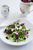 Roasted beetroot salad with rocket, feta cheese, dried blackcurrants and blackcurrant sauce