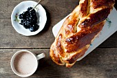 Challah served with a cup of cocoa and blackcurrant jam