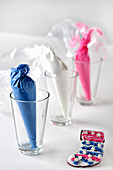 Small cones of sweets in glasses as table decorations