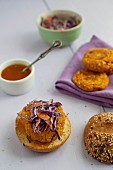 Vegan burgers made from chickpeas, millet and sweet potatoes on wholemeal rolls with red cabbage salad and mango sauce