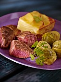 Beefsteak with Brussels sprouts and potato gratin