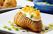 An oven-roasted potato topped with sour cream