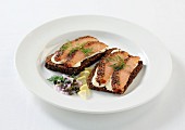 Salmon with a pepper crust on slices of wholemeal bread