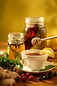 Herb tea being sweetened with honey