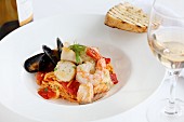 Pasta with tomatoes, fish and seafood