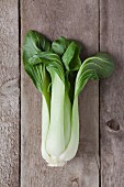 Bok choy on a wooden table (seen from above)