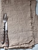 Cutlery on a grey linen cloth
