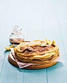 A stack of crepes with cinnamon sugar