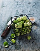 Brussels sprouts in a small wire basket