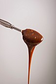 Caramel sauce running off a spoon