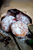 Blackberry doughnuts in a paper bag