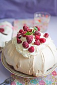 Pavlova (meringue cake) with mascarpone cream and fresh raspberries