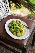 Potatoes with broad beans, yellow courgette and basil pesto