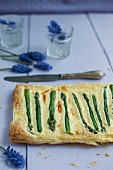 Puff pastry tart with cheese sauce and asparagus