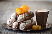 Cannoli with candied oranges served with coffee
