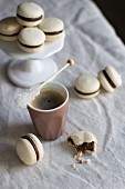Macaroons and coffee with a stick of rock sugar