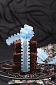 A stack of brownies tied with a blue ribbon