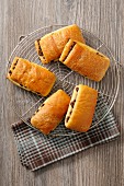 Puff pastries filled with chocolate on a wire rack