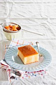 A slice of semolina cake with summer fruit syrup